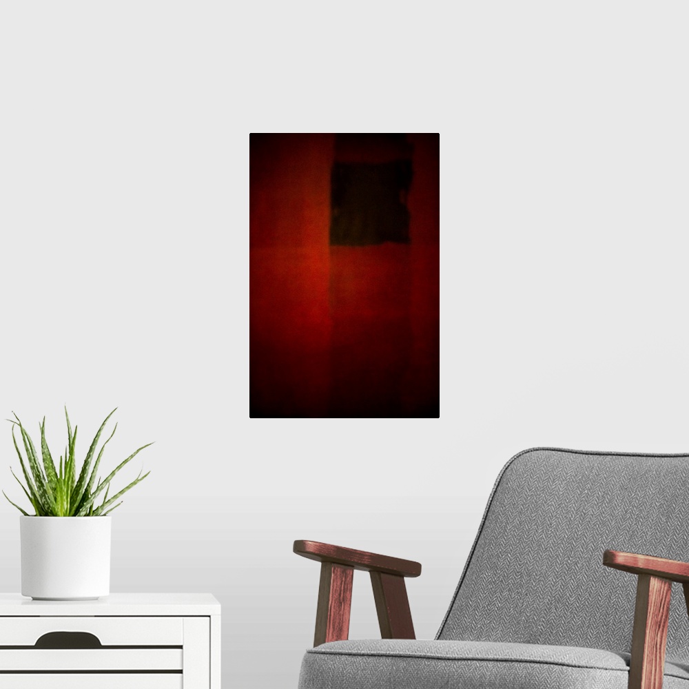 A modern room featuring Geometric abstract artwork that consists of deep reds and subtle polygonal shapes.