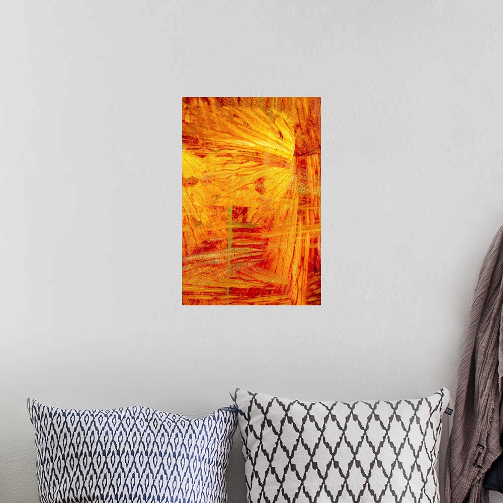 A bohemian room featuring Turbulent slices of reds and yellows fill the space in this abstract artwork.
