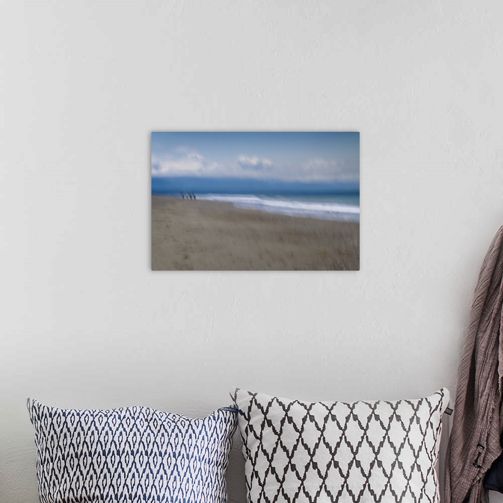 A bohemian room featuring Blurred motion image of a couple walking along the shore.