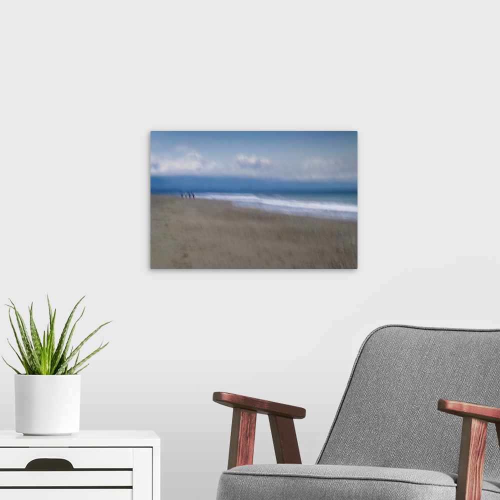 A modern room featuring Blurred motion image of a couple walking along the shore.
