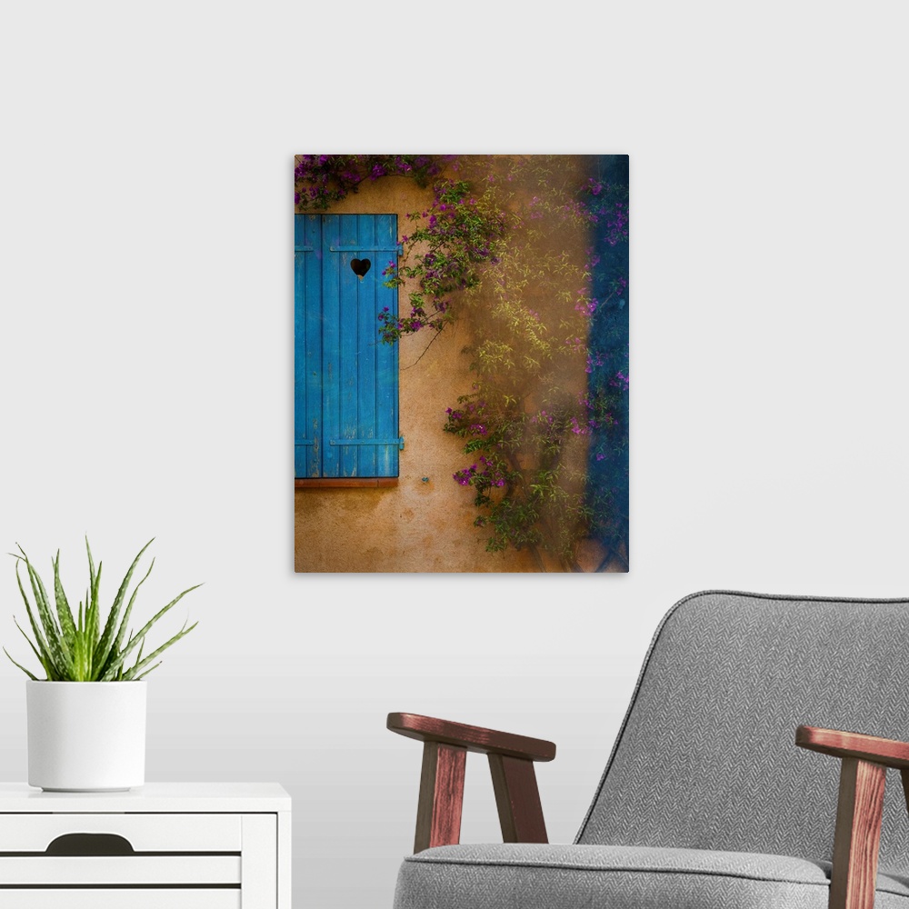 A modern room featuring Photograph of a French facade with a window and blue wooden shutters framed by a vine with little...