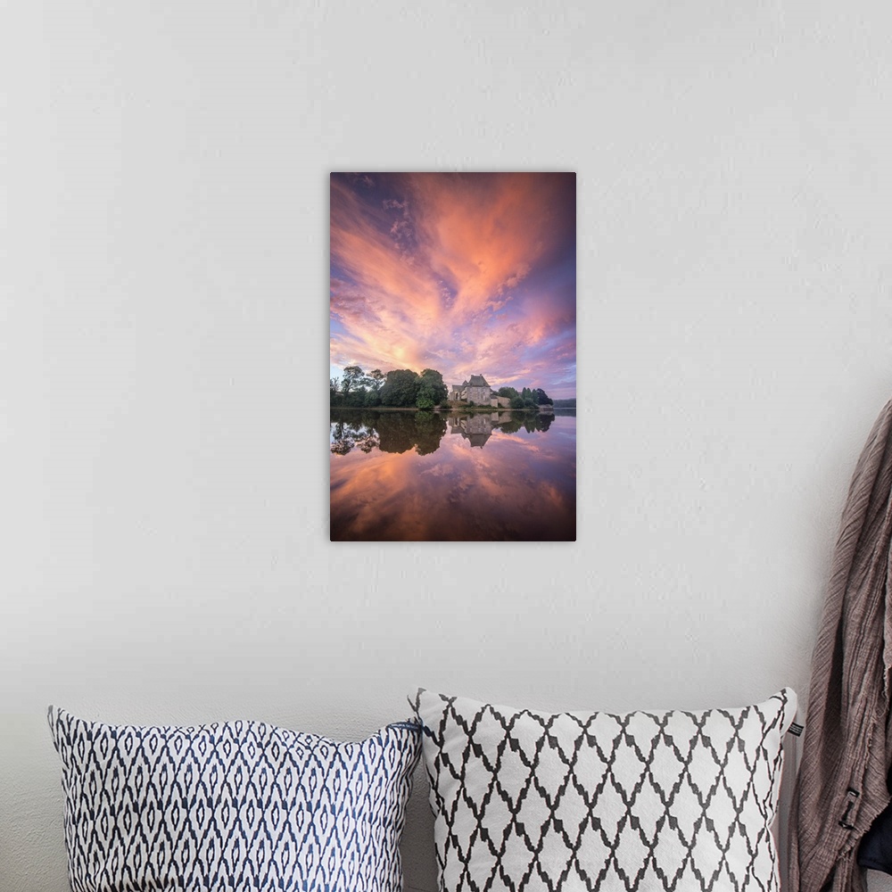 A bohemian room featuring Fiery sunset clouds over a church, reflected in water.