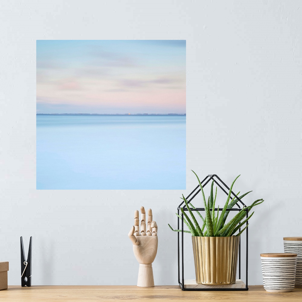 A bohemian room featuring A zen minimalist blue and pink dawn over water with just a distant horizon line and layers of pur...