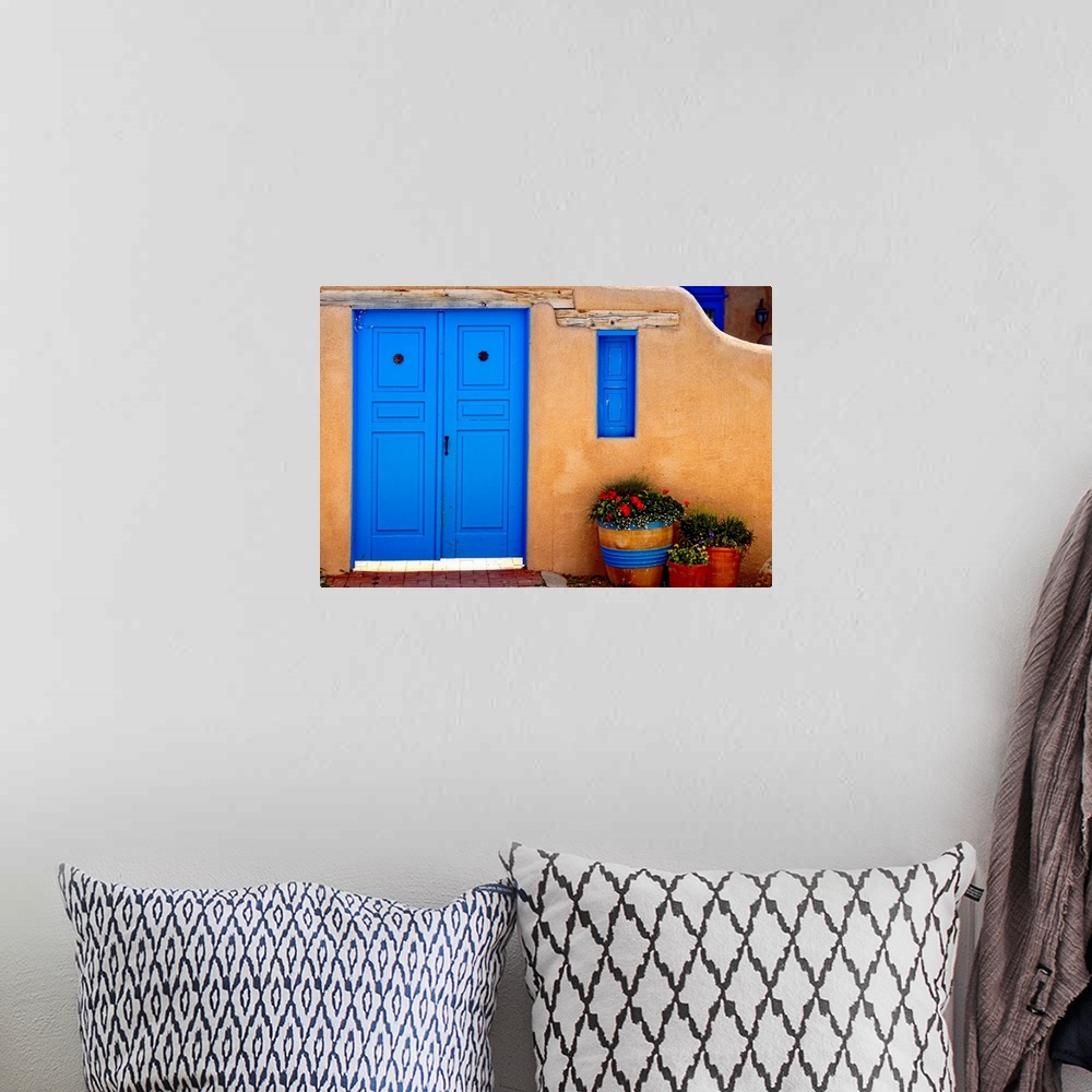 A bohemian room featuring Adobe Walls with Blue Doors, Ranchos De Taos, New Mexico