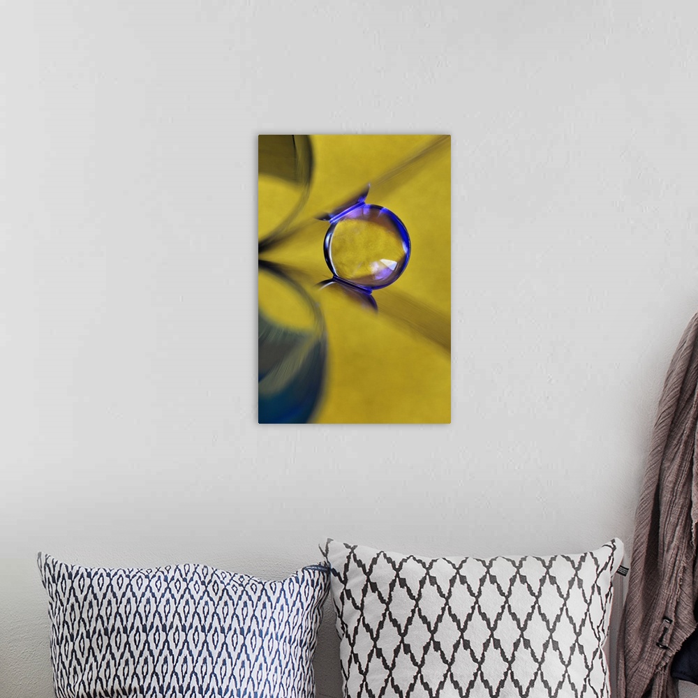 A bohemian room featuring Macro abstract photograph of a water droplet reflecting on a yellow surface.