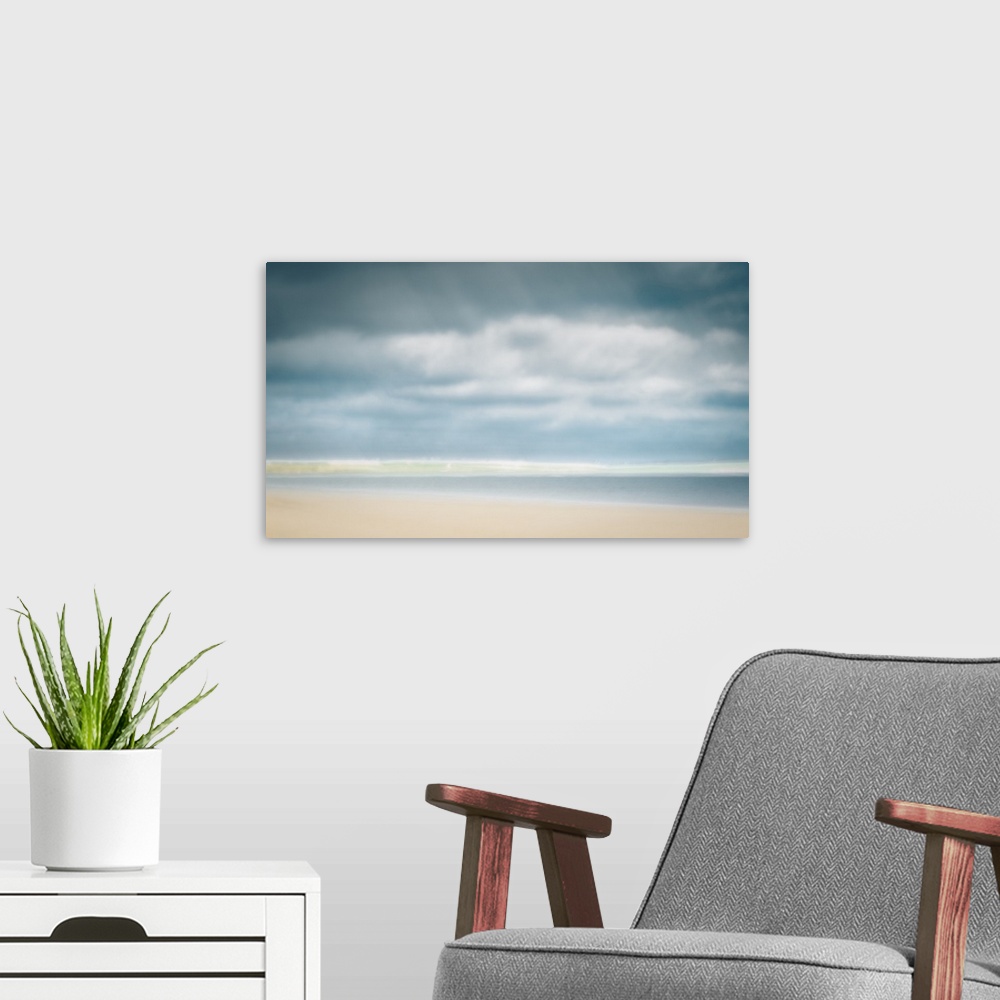 A modern room featuring Impressionist pastel colors of sunny day at the beach with big clouds and sand.
