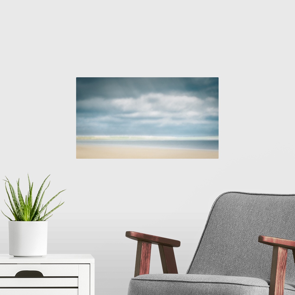 A modern room featuring Impressionist pastel colors of sunny day at the beach with big clouds and sand.
