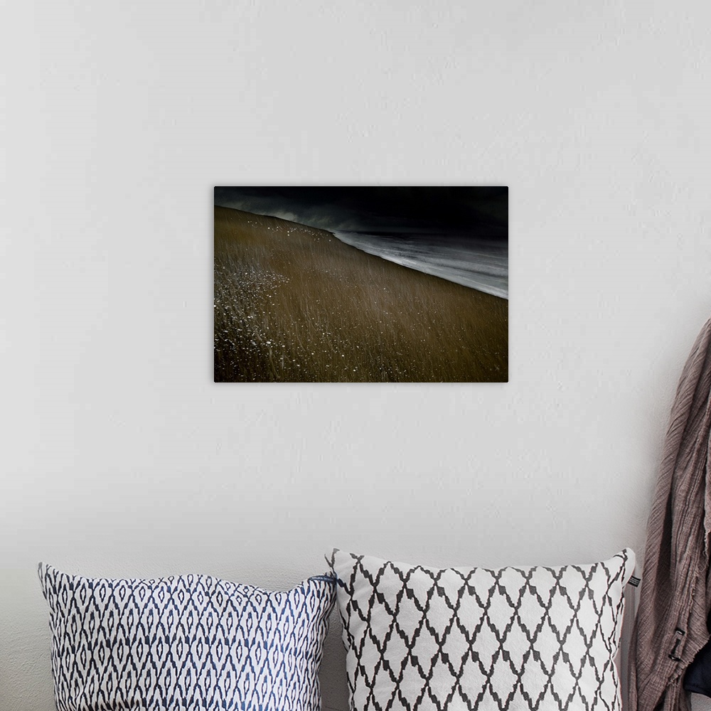 A bohemian room featuring Abstract photograph of a beach landscape with dark ocean waves crashing on a dark sandy beach wit...