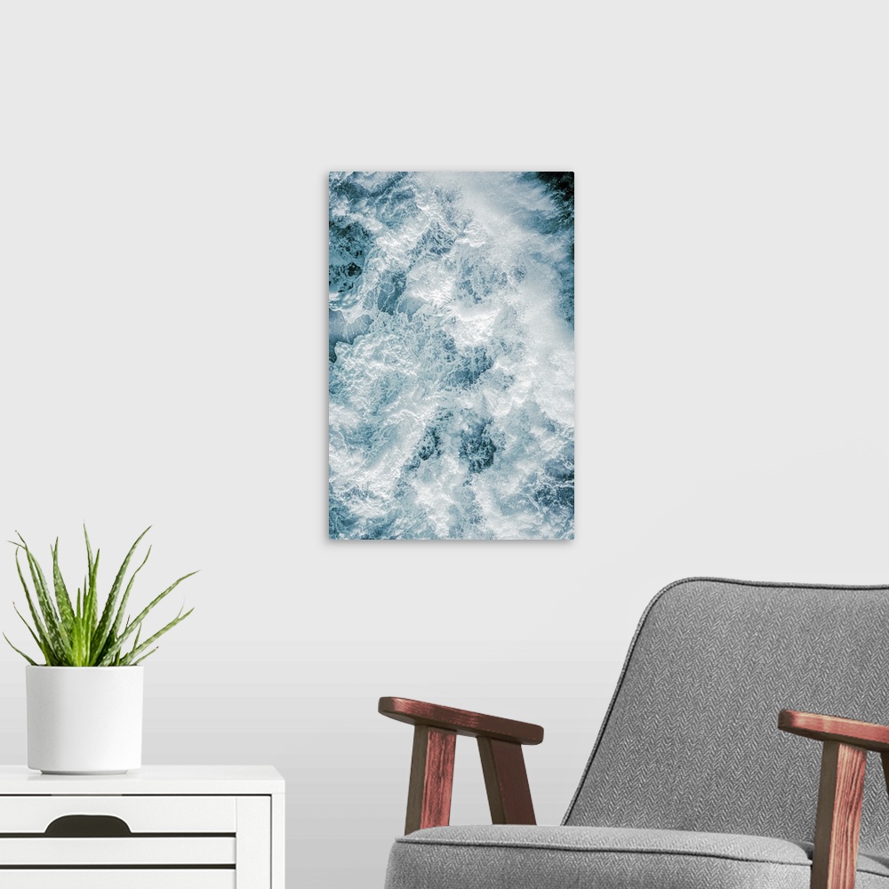 A modern room featuring Aerial photography picture of a huge wave from above showing droplets.