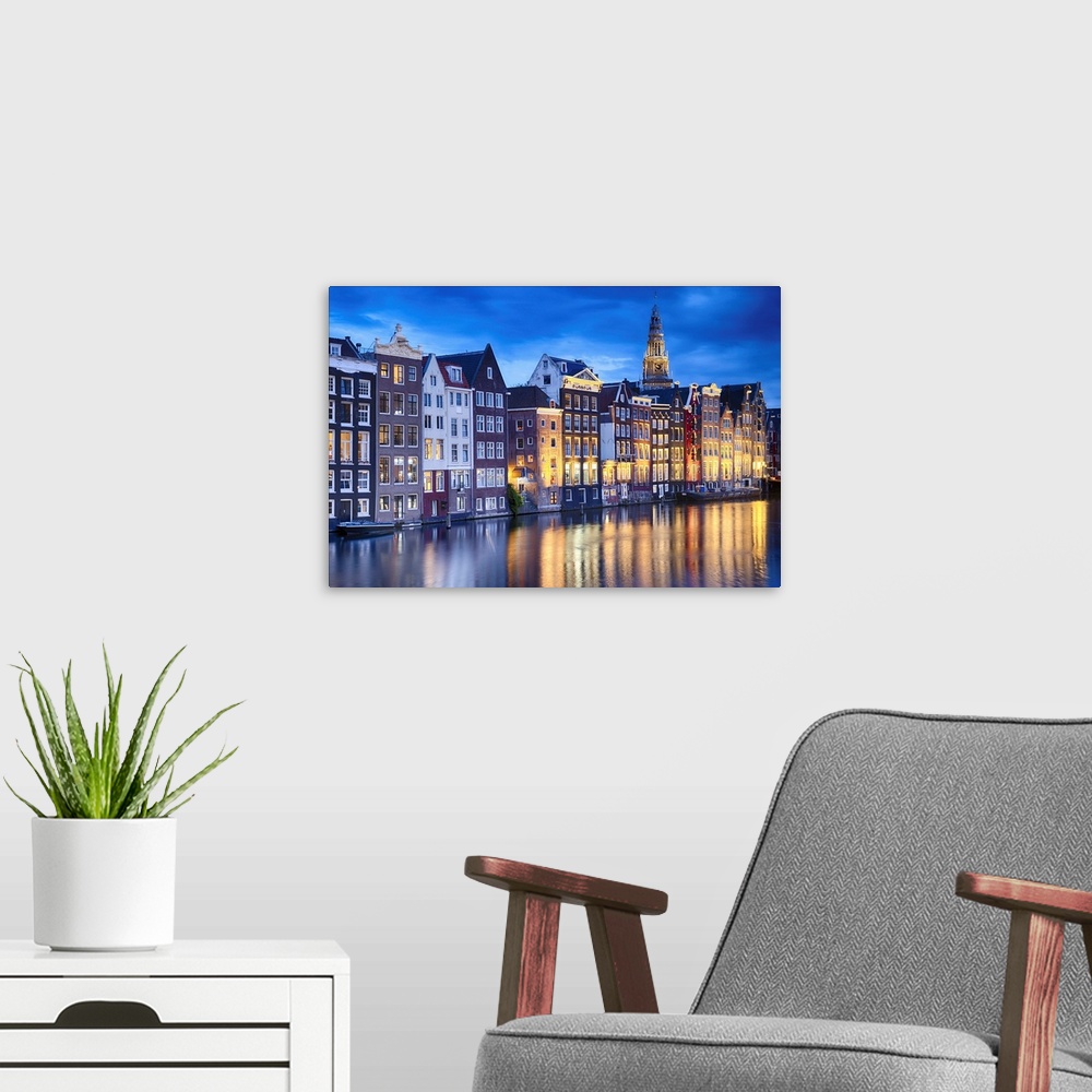 A modern room featuring Amsterdam Illuminated at Dusk with the Oude Church in The Background, North Holland, The Neherklands