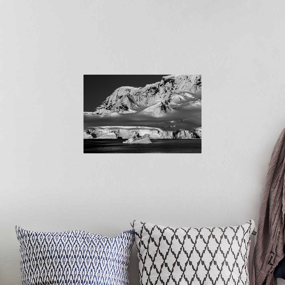A bohemian room featuring Black and white photograph of the cold and lifeless looking landscape of Antarctica.