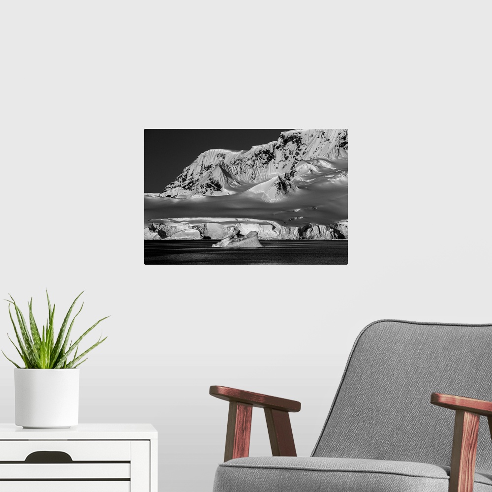 A modern room featuring Black and white photograph of the cold and lifeless looking landscape of Antarctica.