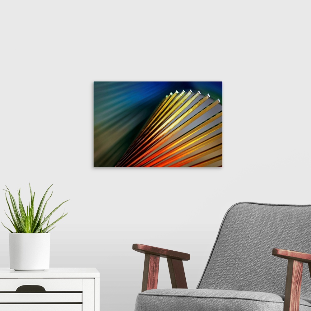 A modern room featuring Abstract photo of various colored lines with light shining on them.