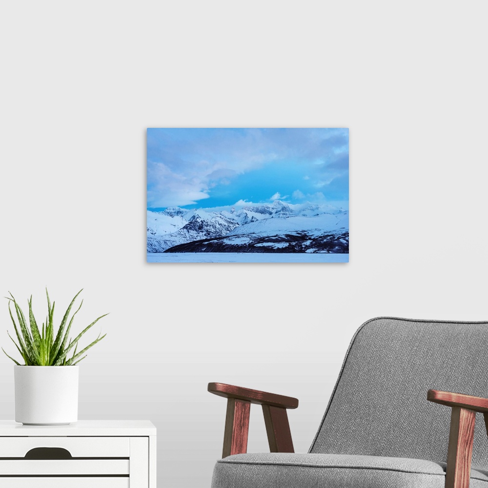 A modern room featuring Snowy mountains landscape on blue sky background in Iceland