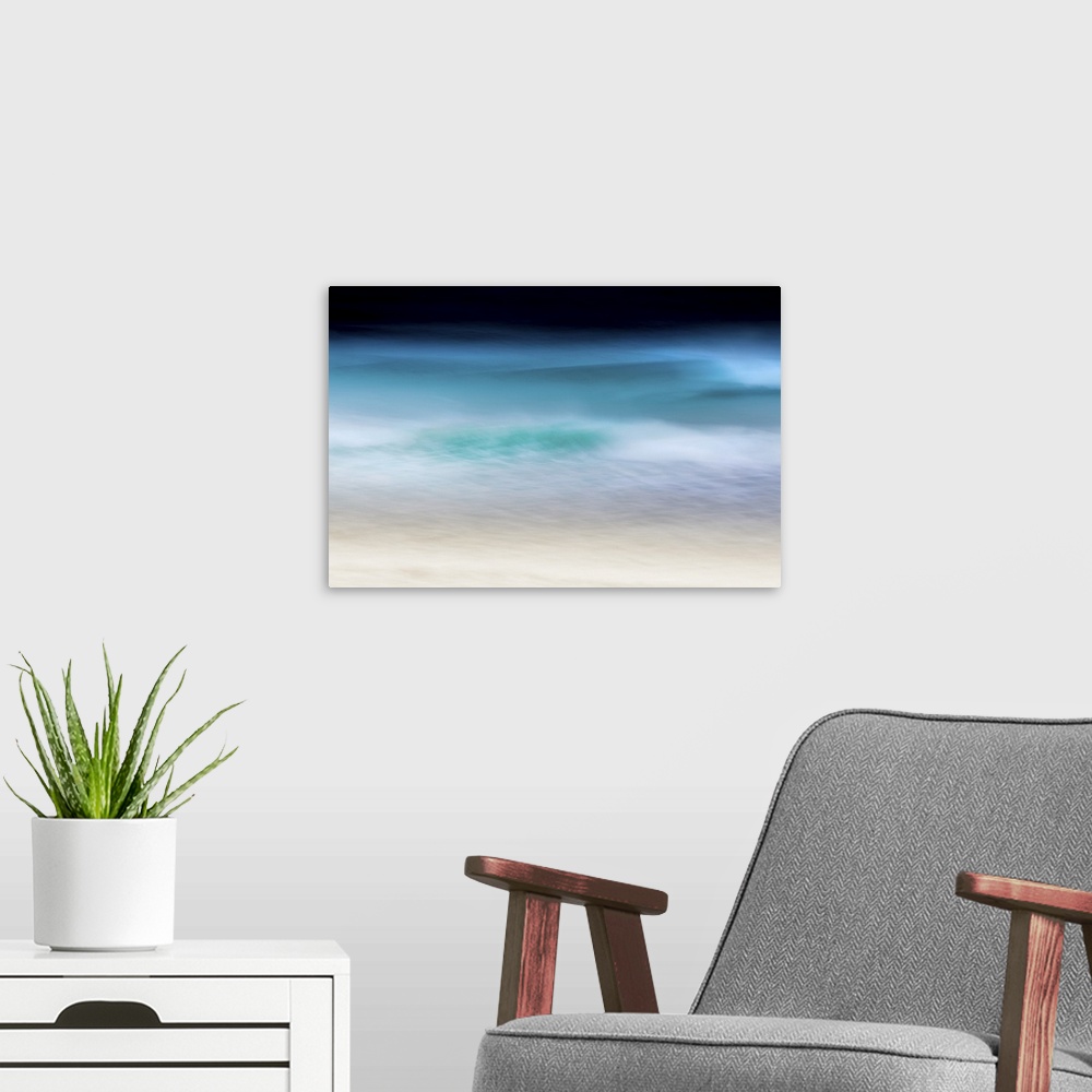A modern room featuring Abstract seascape of teal waves breaking over soft sand with moody sky.