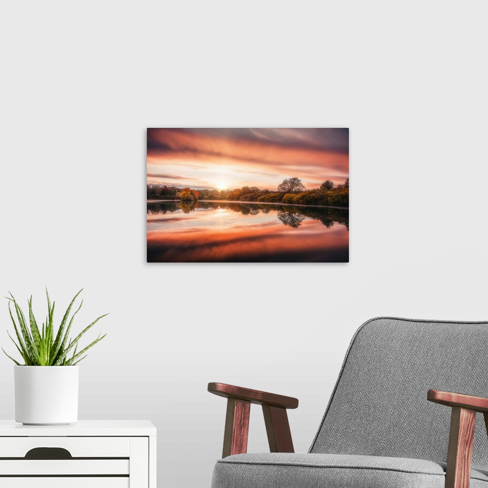 A modern room featuring Sunset over a lake in autumn with a beautiful reflection