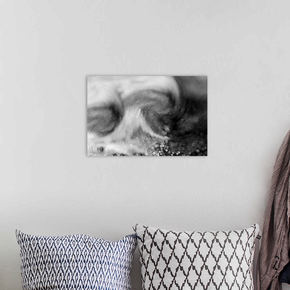 A bohemian room featuring A macro black and white photograph of swirling water.
