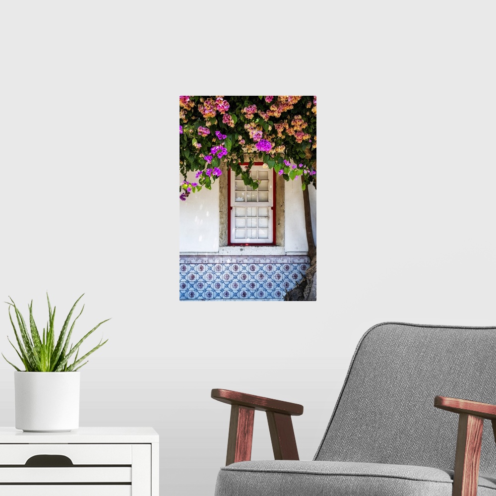 A modern room featuring Window in old town Lisbon with azulejos and blossoming tree, Portugal.