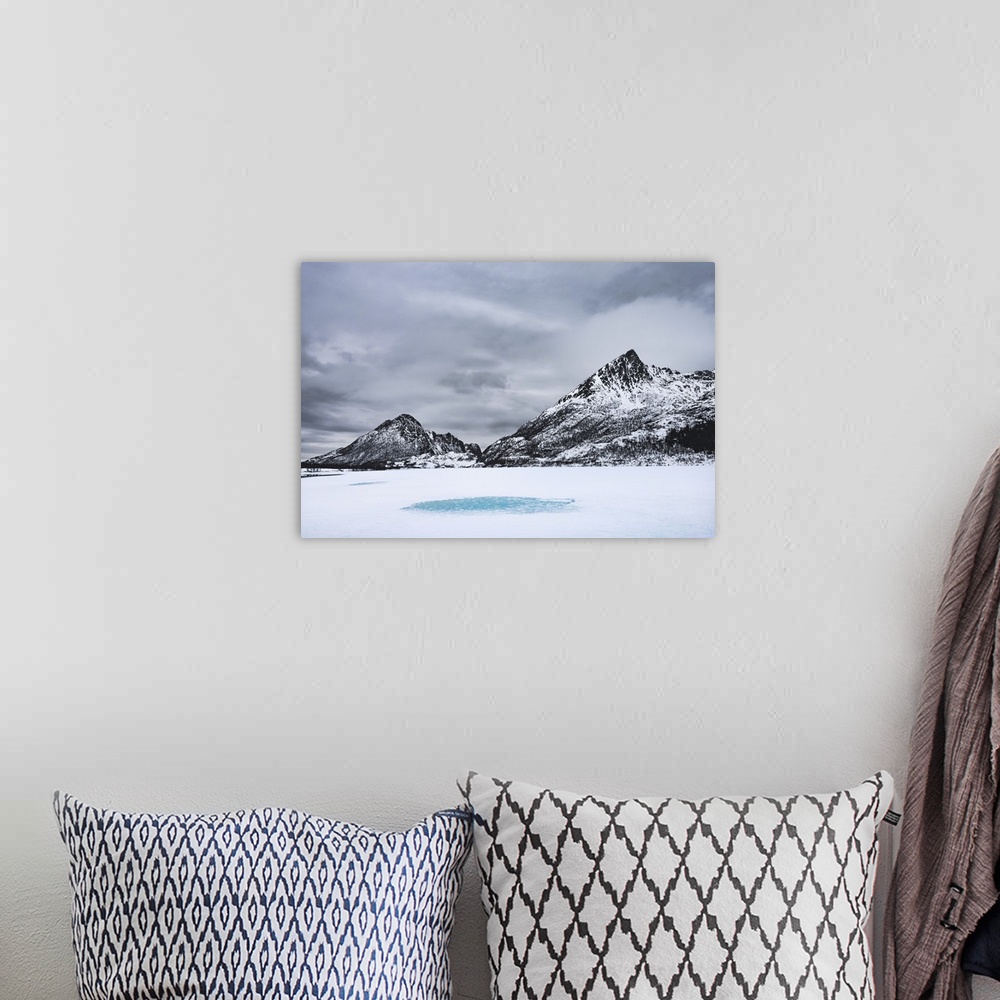 A bohemian room featuring Snow-covered landscape with mountains around a frozen lake