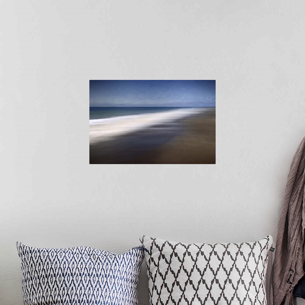 A bohemian room featuring Blurred long-exposure image of the foamy sea on a sandy beach, moving with the tide.