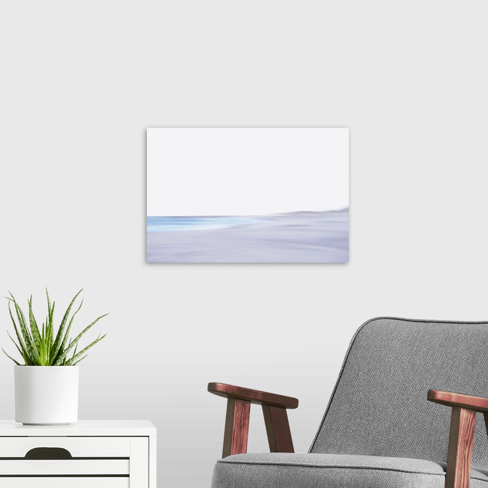 A modern room featuring Artistically blurred photo. The North Sea beach of North Jutland, Denmark. A seagull flies to the...