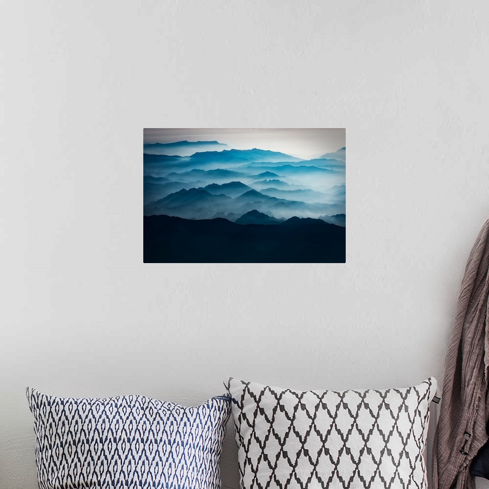A bohemian room featuring Blue mountains with mist taken from the sky, mountains of Asia