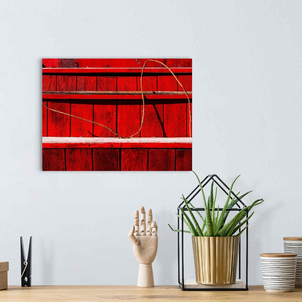 A bohemian room featuring Wire on a red wooden staircase, creating an abstract image.
