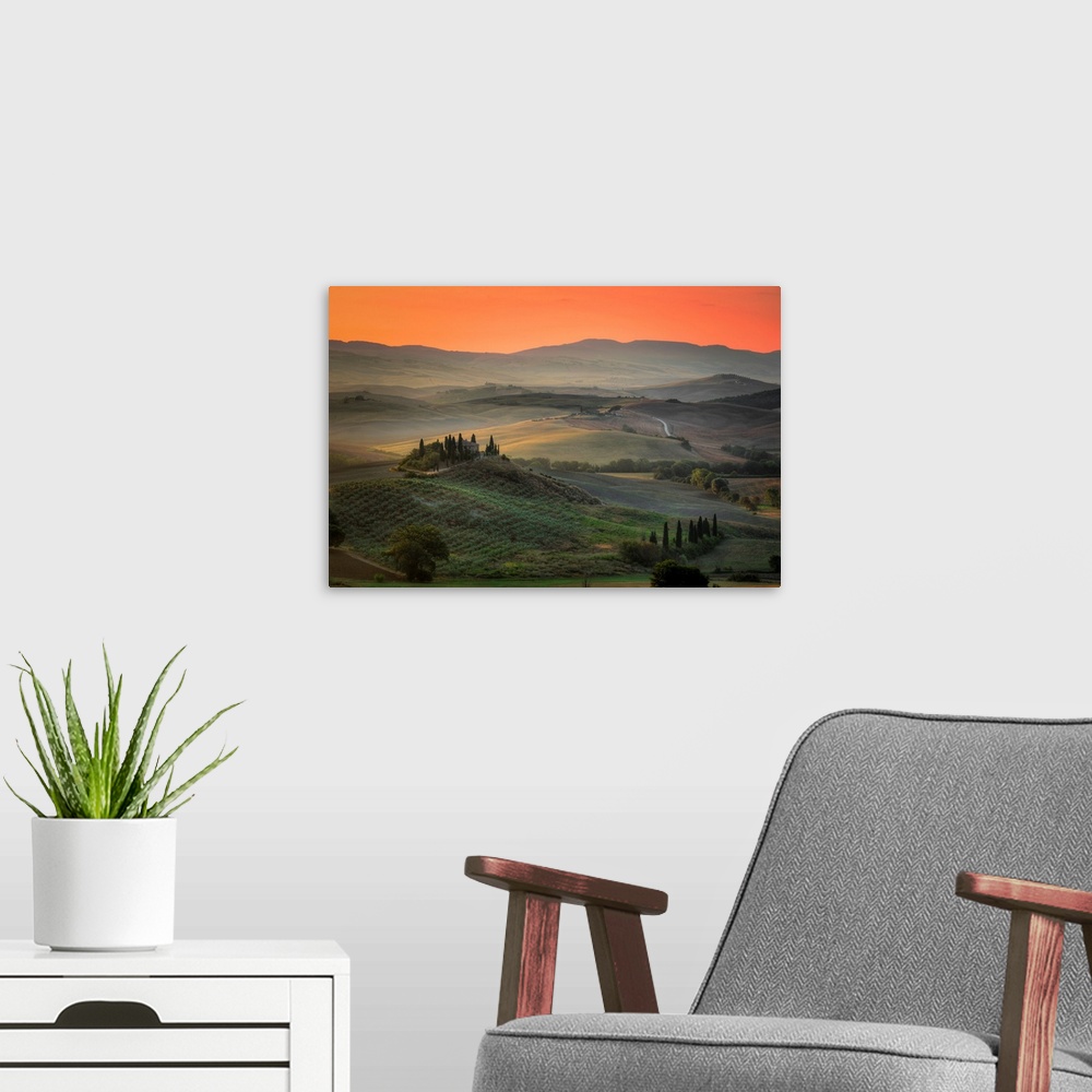 A modern room featuring Sunrise in the rolling hill countryside of Tuscany in Italy.