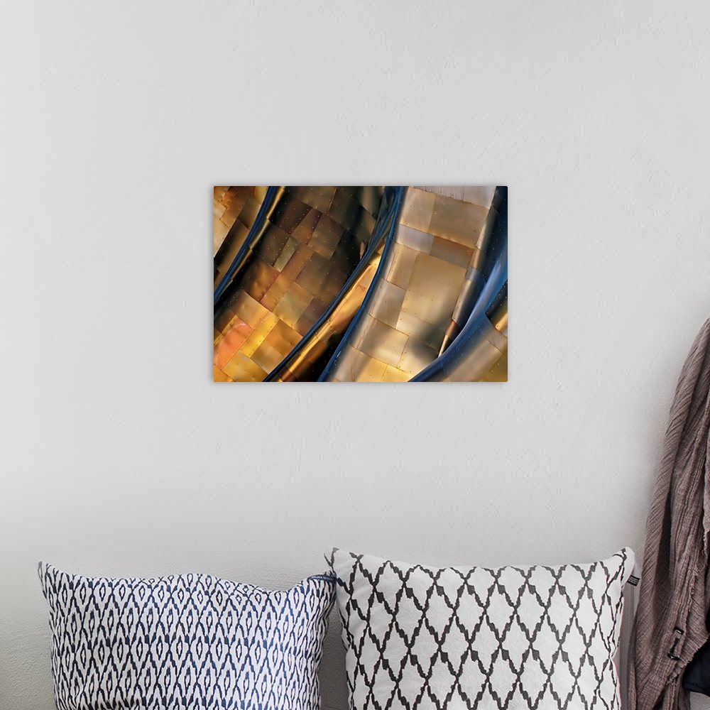 A bohemian room featuring Abstract photograph of a large metal structure reflecting blue and gold light.