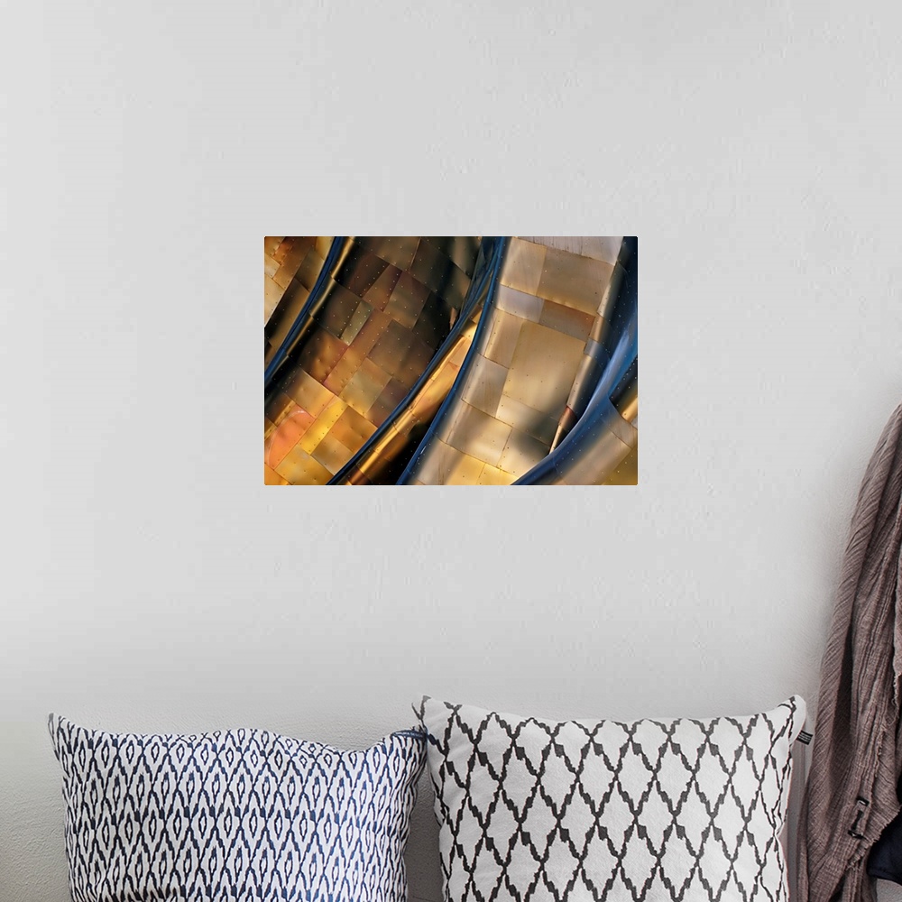 A bohemian room featuring Abstract photograph of a large metal structure reflecting blue and gold light.