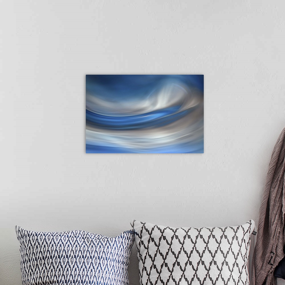 A bohemian room featuring Abstract photograph of blurred and blended colors and flowing lines in shades of blue and white.