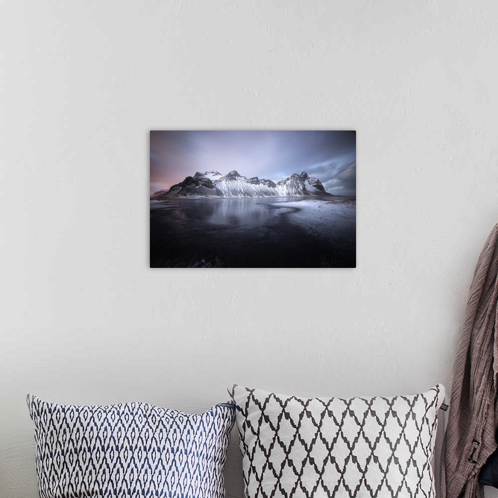 A bohemian room featuring Pastel sky over dark mountains covered in fresh snow in Stokksnes, Iceland.