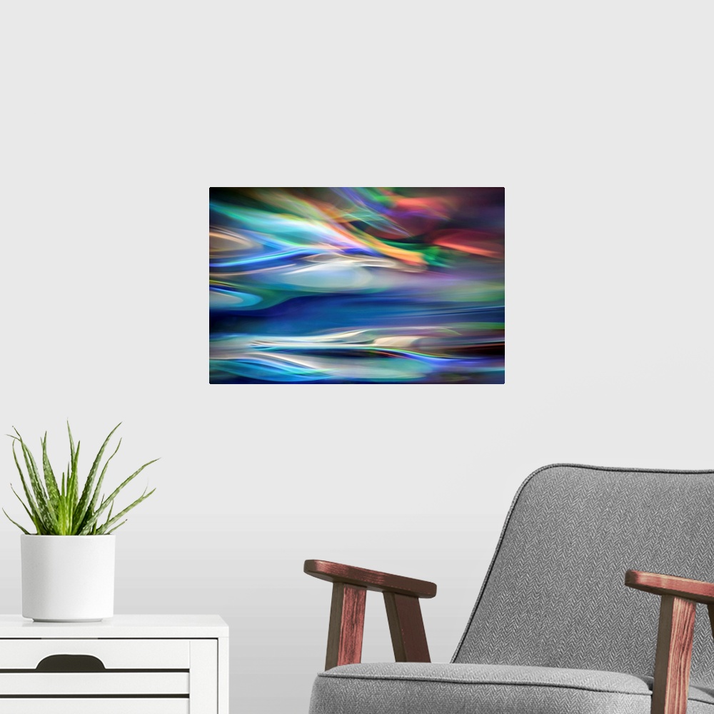 A modern room featuring Wall art that has moving multicolored lines that are composed in an abstract fashion.