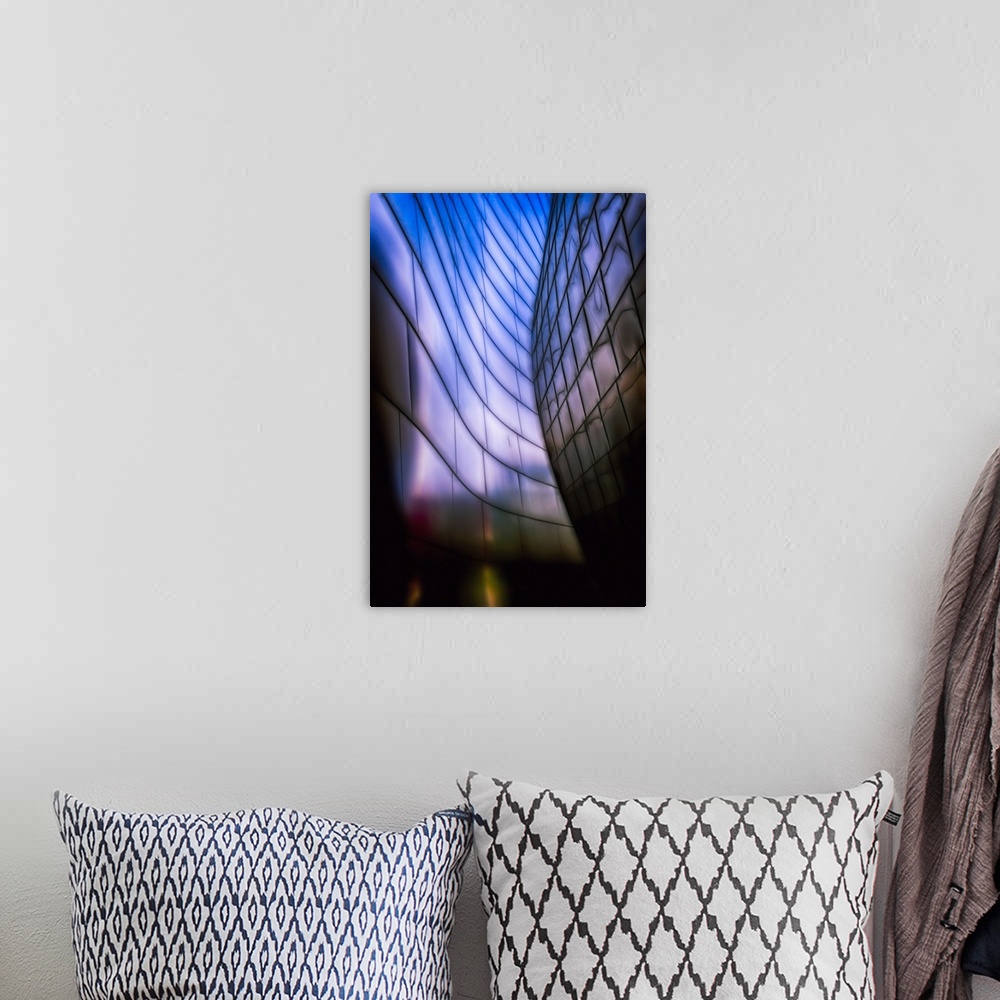 A bohemian room featuring A Vertical photograph of architectural detail of Reflective Metal Plates in Soft Blue Light.