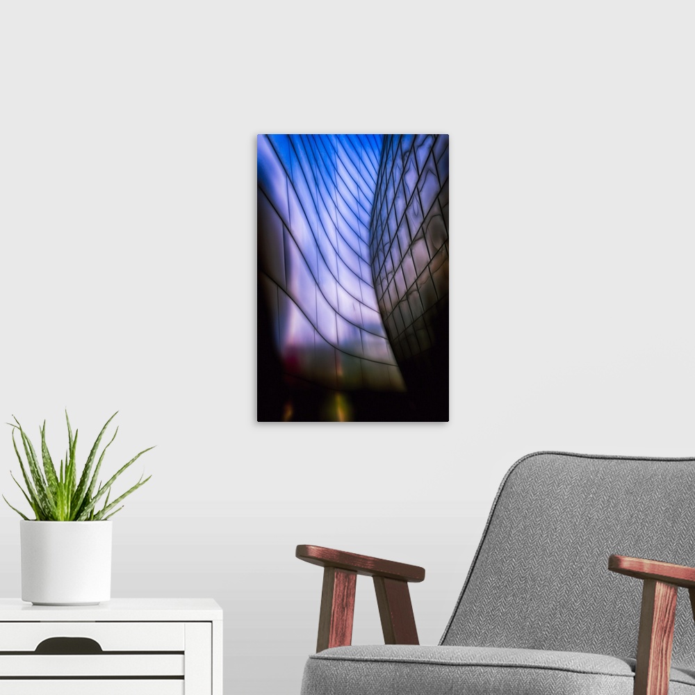 A modern room featuring A Vertical photograph of architectural detail of Reflective Metal Plates in Soft Blue Light.