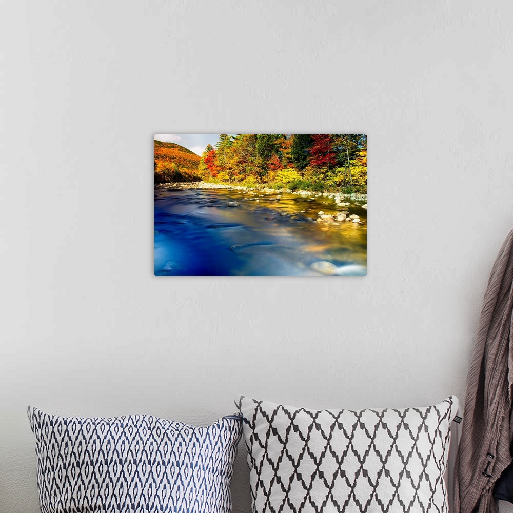 A bohemian room featuring Fine art photo of a clear river near a forest in the fall in New England.