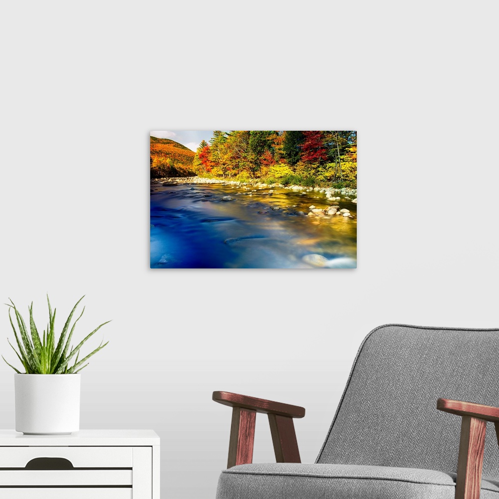 A modern room featuring Fine art photo of a clear river near a forest in the fall in New England.