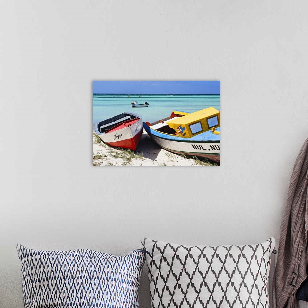 A bohemian room featuring A photograph of colorful boats sitting on the shore of a tropical beach.