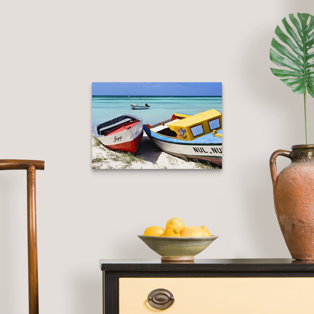 A traditional room featuring A photograph of colorful boats sitting on the shore of a tropical beach.