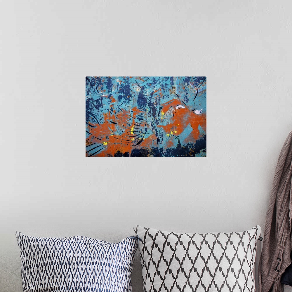 A bohemian room featuring Close up of graffiti on a wall, creating an abstract image in turquoise and orange.