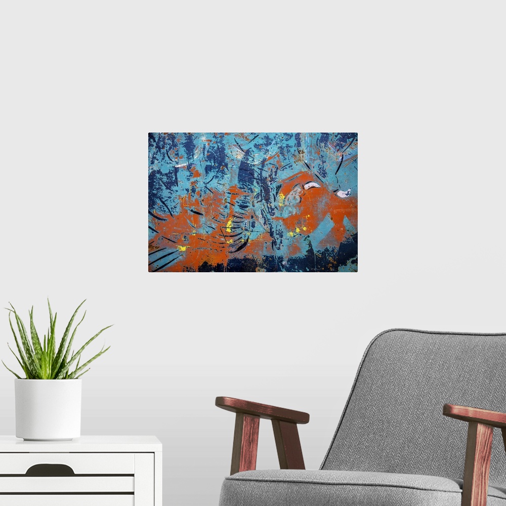 A modern room featuring Close up of graffiti on a wall, creating an abstract image in turquoise and orange.