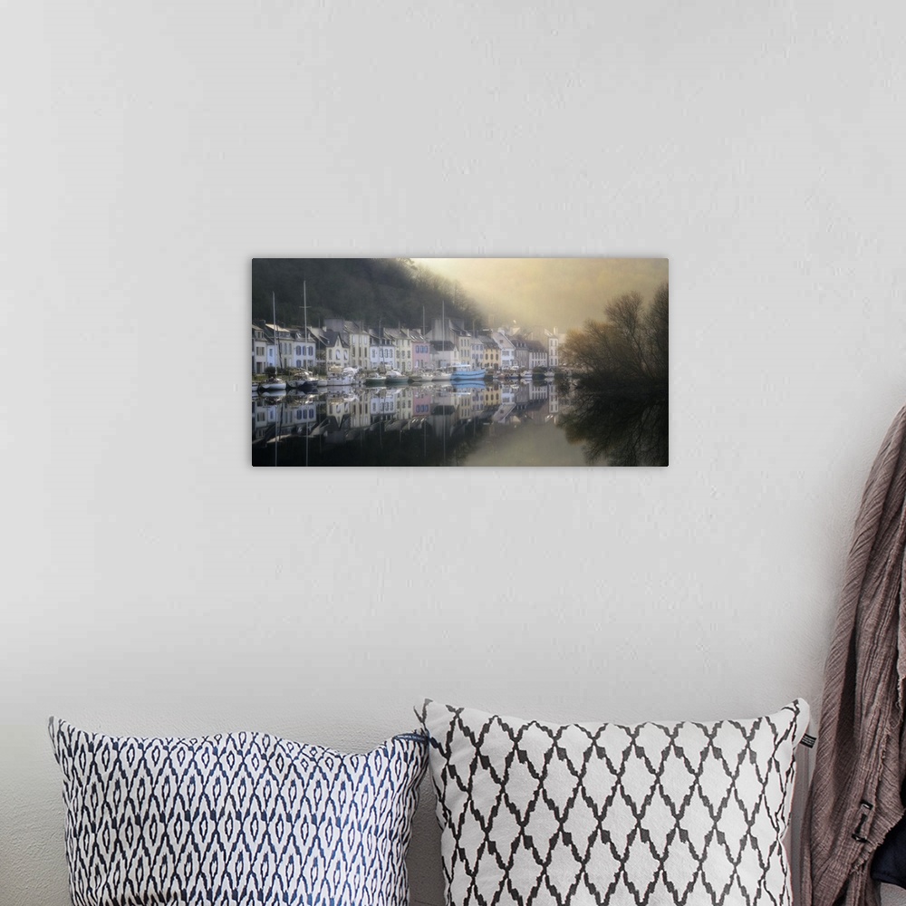 A bohemian room featuring A photograph of a foggy marina in a small French village.