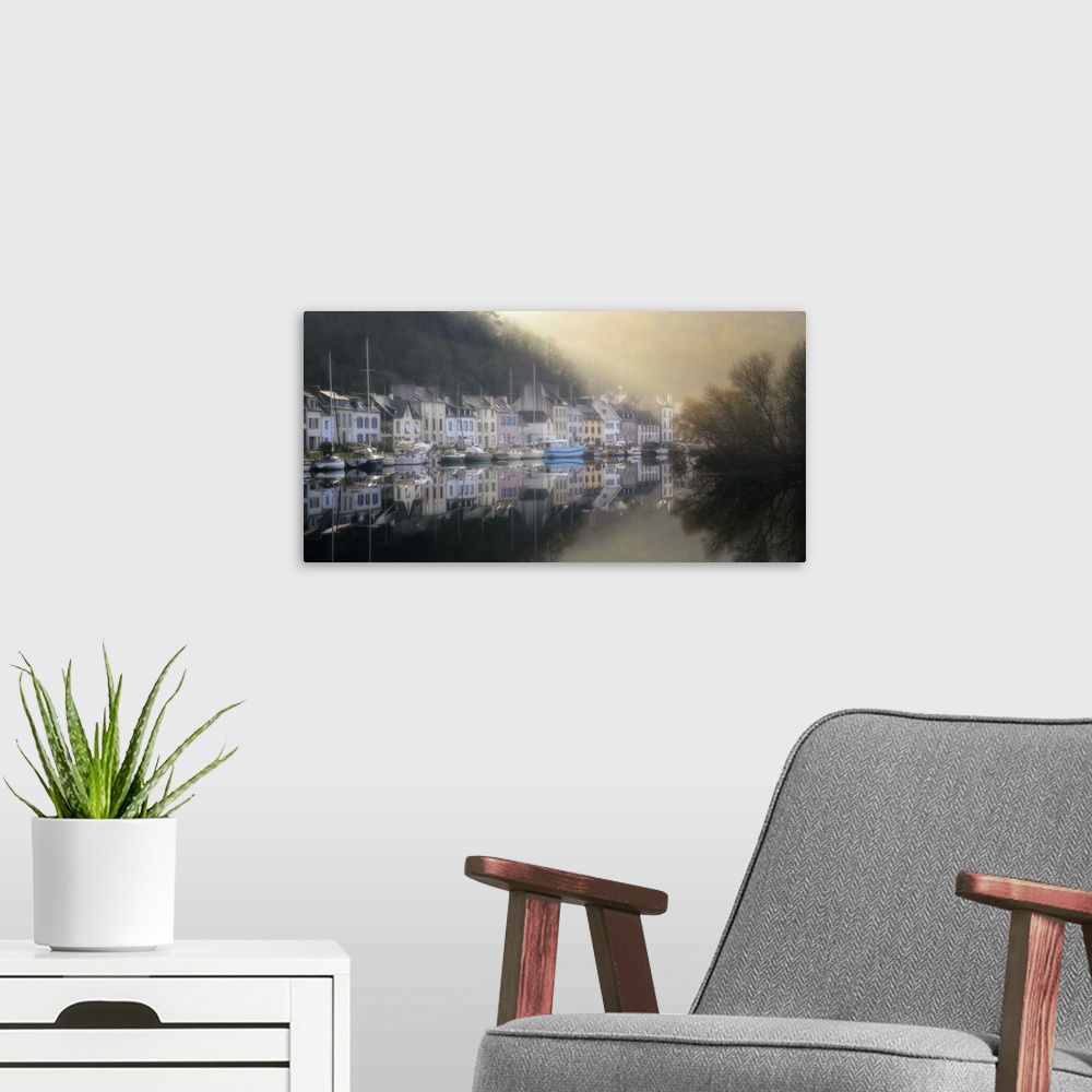 A modern room featuring A photograph of a foggy marina in a small French village.