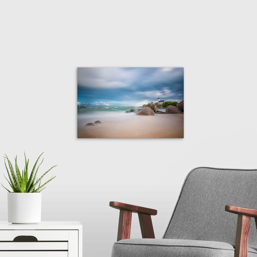 A modern room featuring A photograph of the French coast under a blanket of soft clouds.