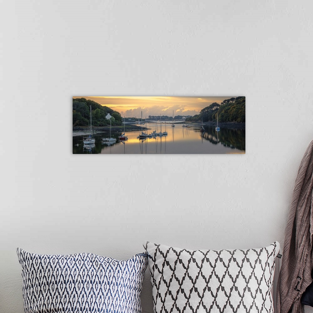 A bohemian room featuring Sailboats in the harbor of the Wrac'h river in a small fishing village in France at sunset.