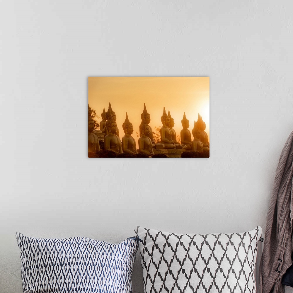 A bohemian room featuring Sunset in front of rows of buddhas