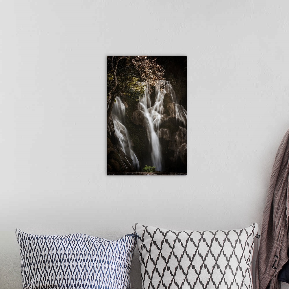 A bohemian room featuring Waterfall in a forest between shadows and light