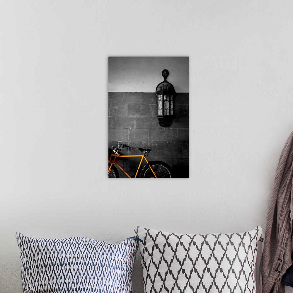 A bohemian room featuring Contemporary photograph of brightly colored bicycle with antique light fixture on brick wall in b...