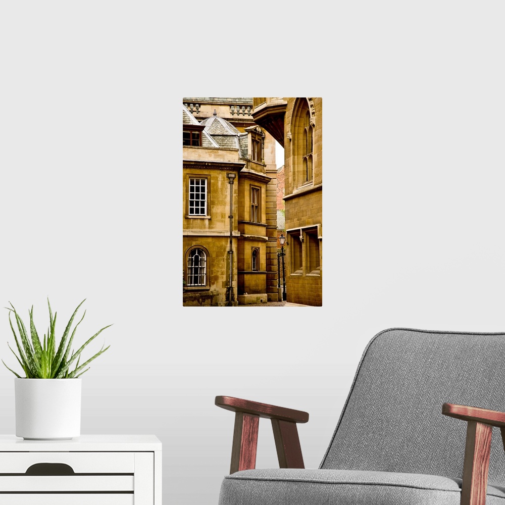 A modern room featuring A view of ancient buildings in yellowed stone in Cambridge, England.