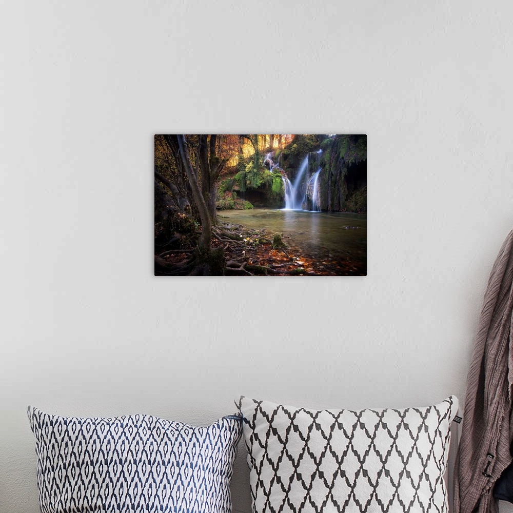 A bohemian room featuring Fine art photograph of a waterfall in a forest in France.